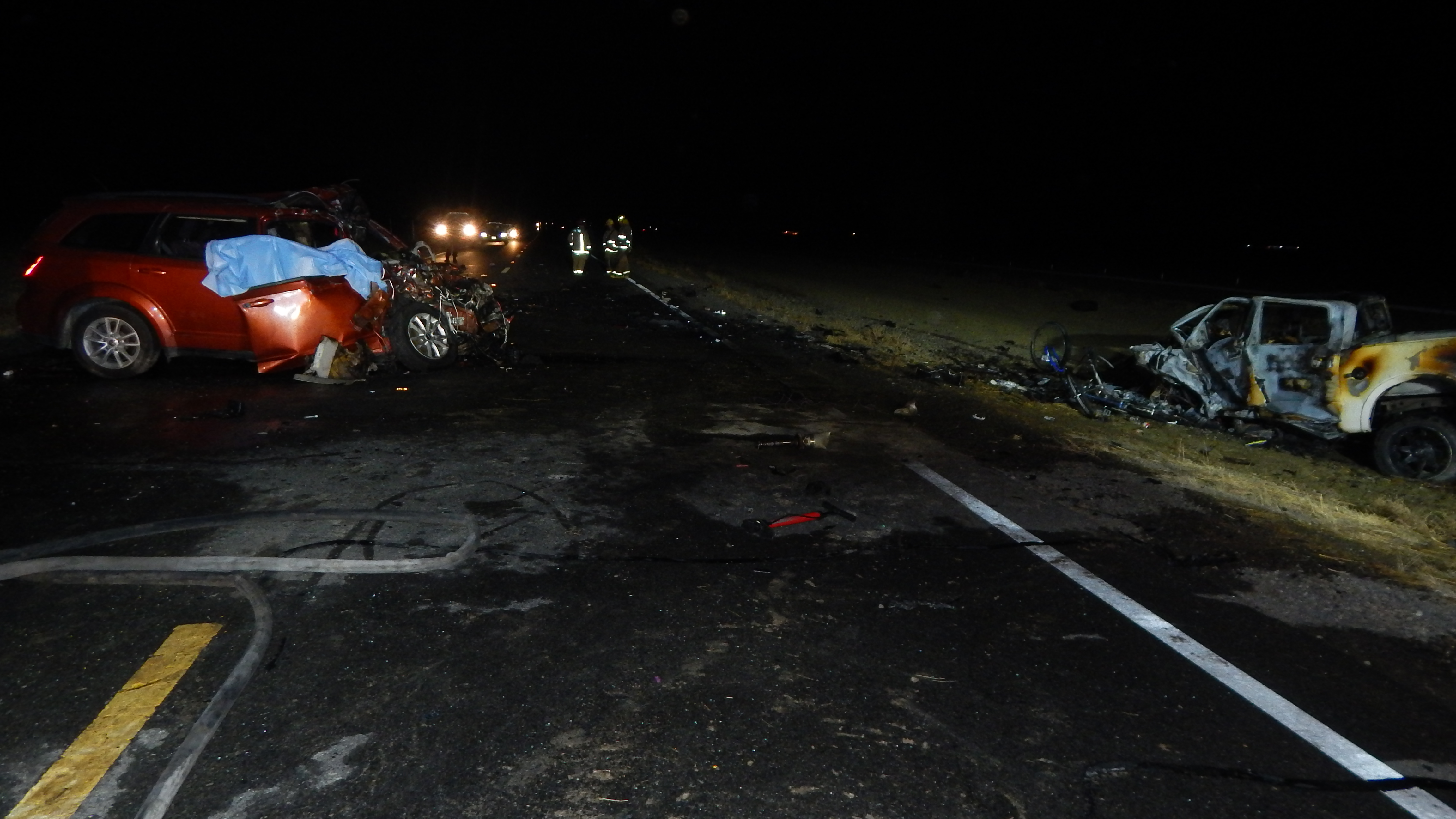 Northbound view of vehicles postcrash with SUV in southbound lane of SR-33 and  truck off east road edge 